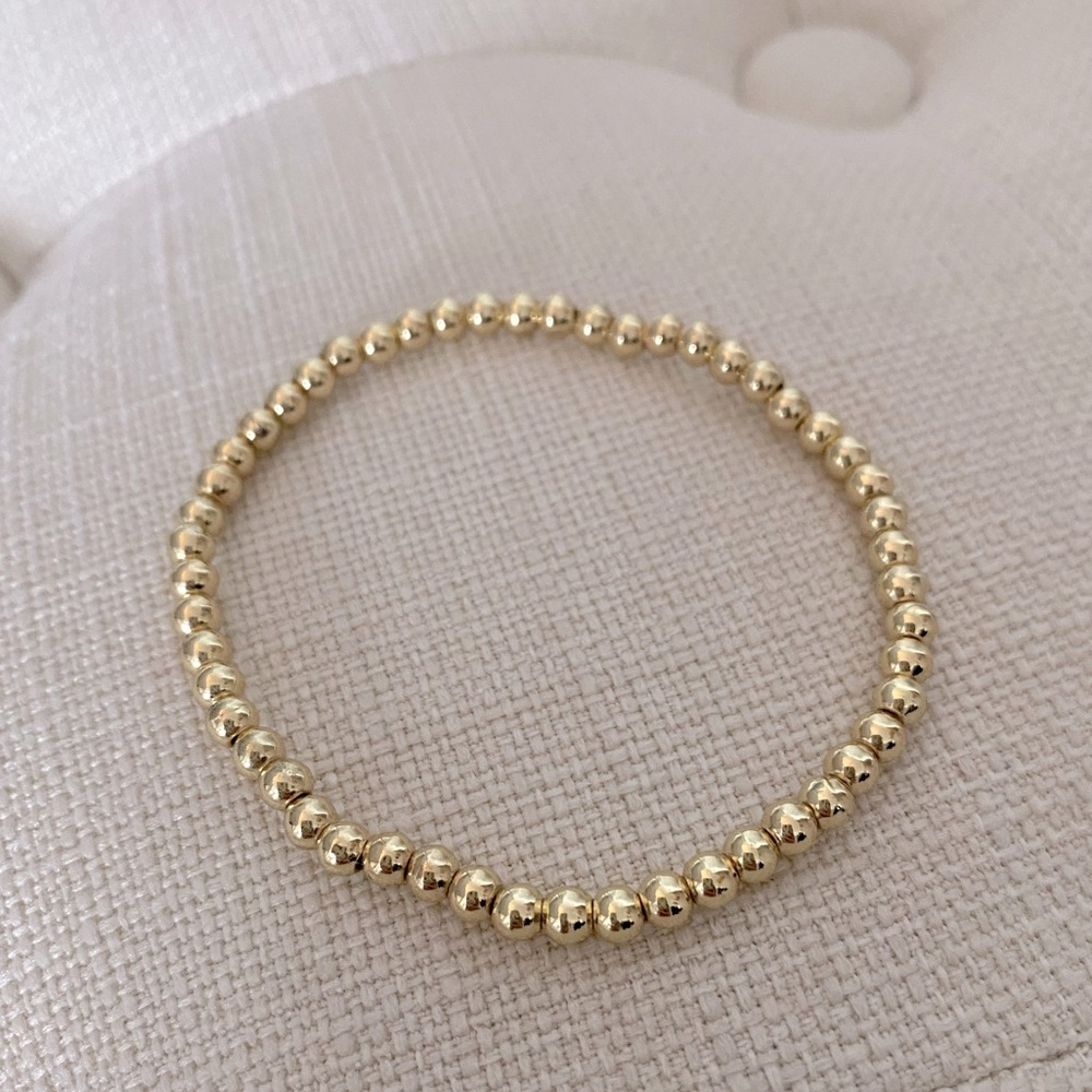 NWOT Gold tone elastic bead bracelet